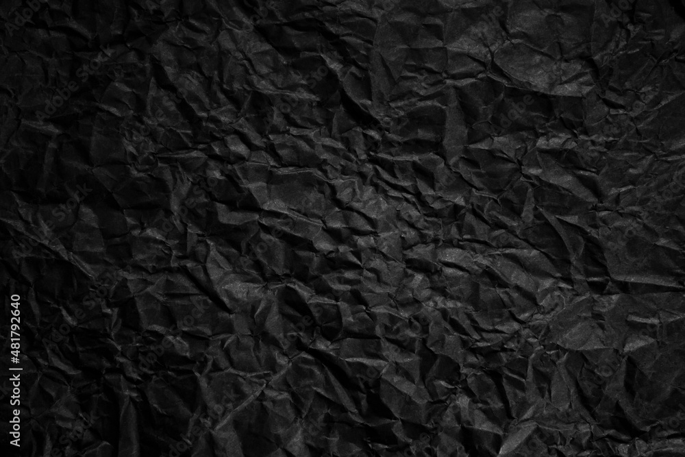 Textured crumpled black paper background.