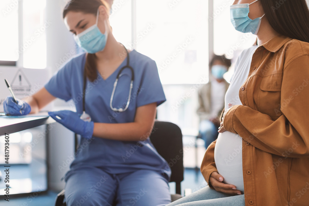Pregnant Lady In Mask On Appointment At Doctor's Office Pregnant Lady In Mask On Appointment At Doctor's Office