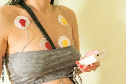 Holter monitor sensors on a woman's chest.