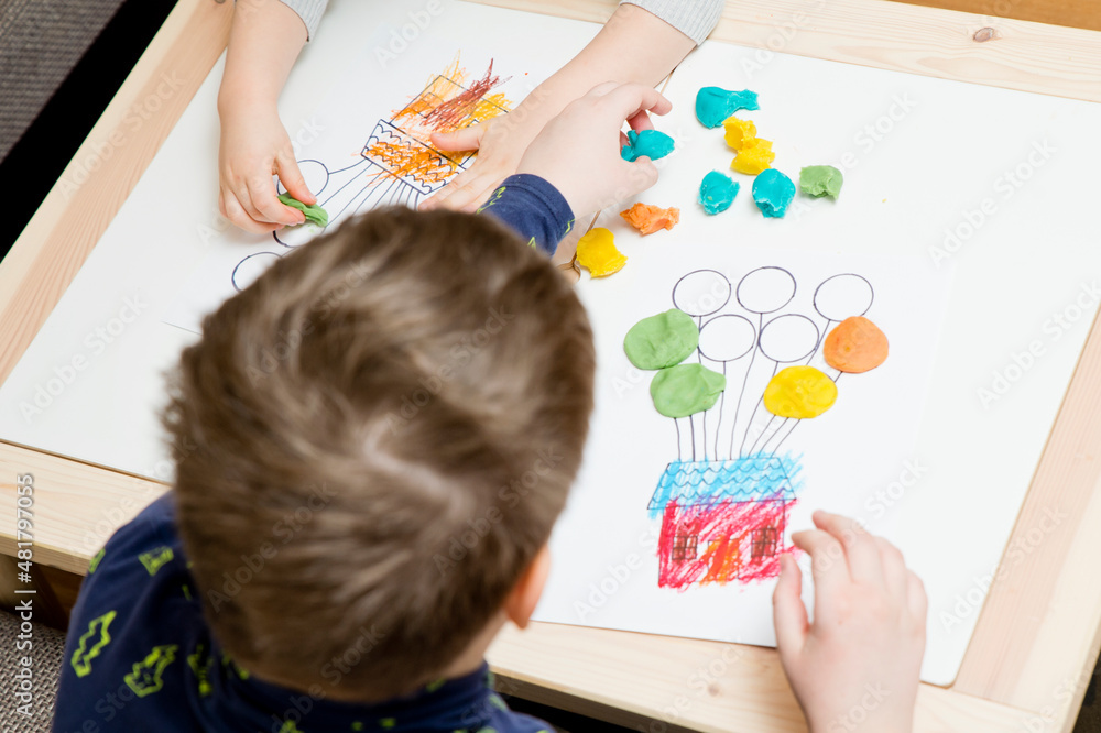 Little hands coloring drawing of house with balloons with colored wax crayons. exercise for hand-eye coordination, stimulate imagination, creativity, develop fine motoric skills. Little hands coloring drawing of house with balloons with colored wax crayons. exercise for hand-eye coordination, stimulate imagination, creativity, develop fine motoric skills.
