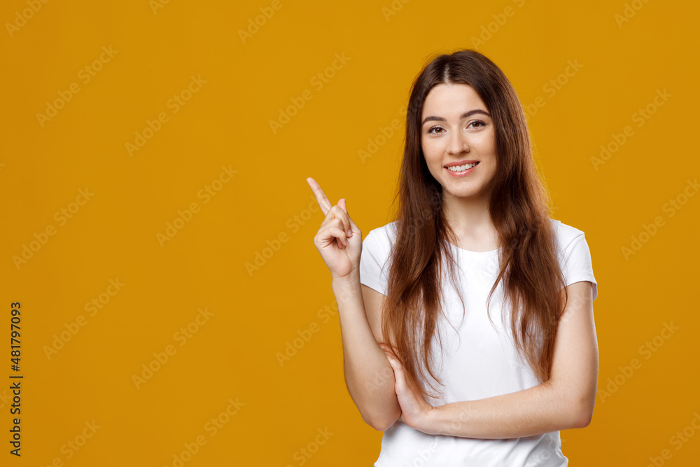 Cheerful lady posing over colorful background, pointing at copy space Cheerful lady posing over colorful background, pointing at copy space