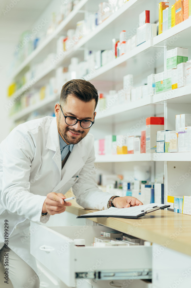 Portrait of a handsome pharmacist working in a pharmacy