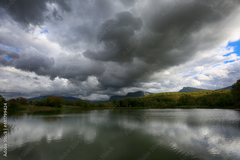 Beautiful landscape near the lake with storm clouds