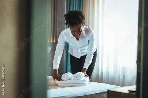 Free Download Female chambermaid holding clean white folded towels in bedroom. Cleaning the hotel room. Copy space. The concept of the hotel business. Change of towels in the hotel room. - GFXLoad