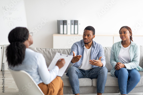 Young black couple on meeting with marital counselor, working on their relationship at psychologist's office