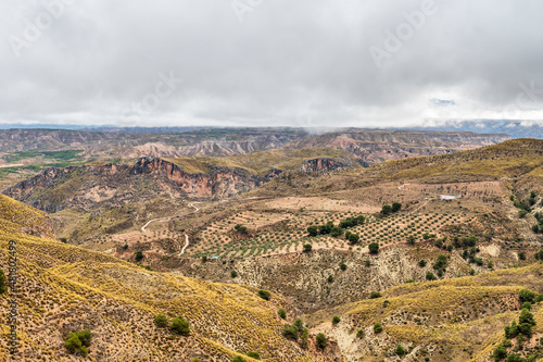 Ridges and cliffs of the Badland de los Coloraos in the Geopark of Granada photo