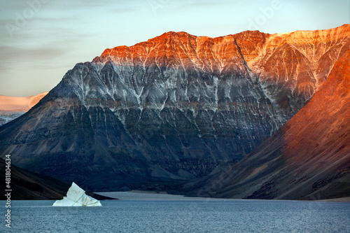 First rays of dawn sunlight on the mountain tops of Blomsterbugten in Kaiser Franz Joseph Fjord on the northeast coast of Greenland. photo