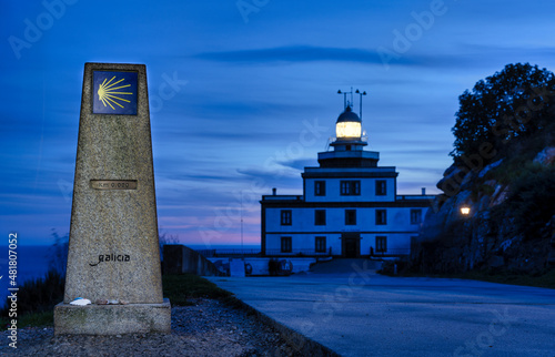 Mile zero of the Camino de Santiago in Finisterre, Galicia with the lighthouse in the background. photo