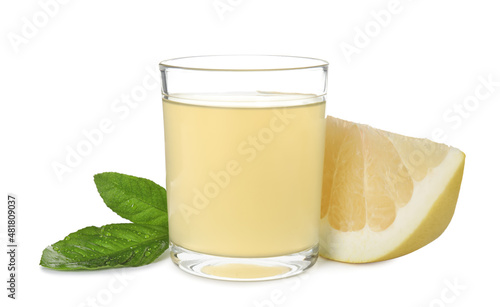 Glass of fresh pomelo juice, fruit and green leaves isolated on white