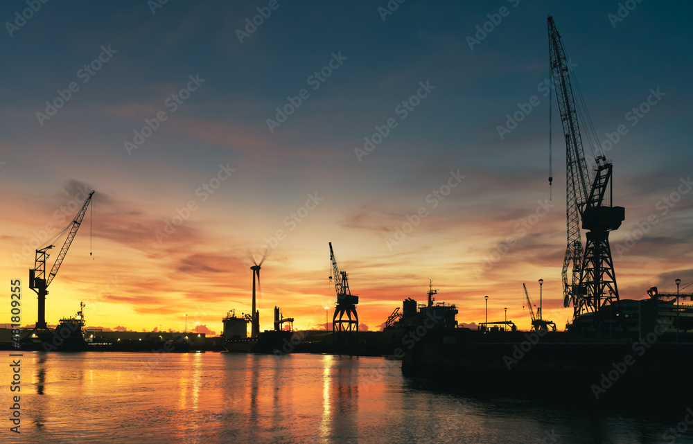 Silhouette of large industrial cranes International Container Cargo Port - Shipyards of Viana do Castelo, Portugal - Freight Transportation, Shipping - Landscape background