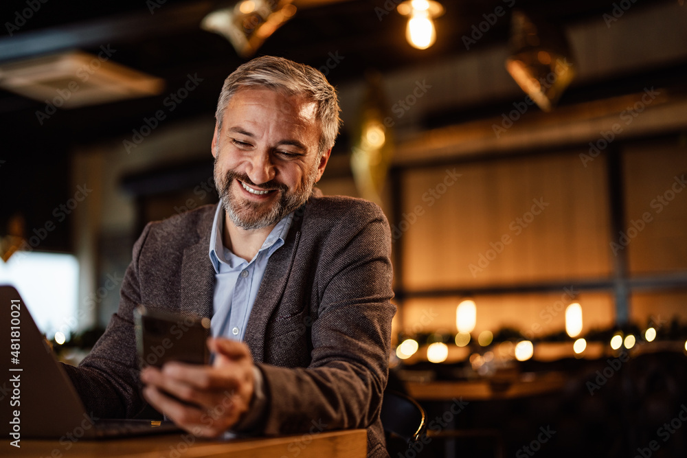 Cheerful bearded caucasian man, receiving a nice message on his Cheerful bearded caucasian man, receiving a nice message on his