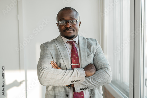 Portrait of an adult african man in suit in glasses 