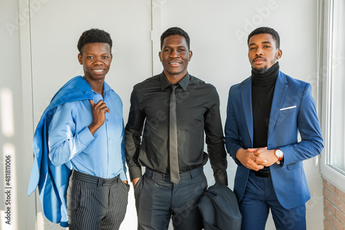 three african attractive males indoors in suits 