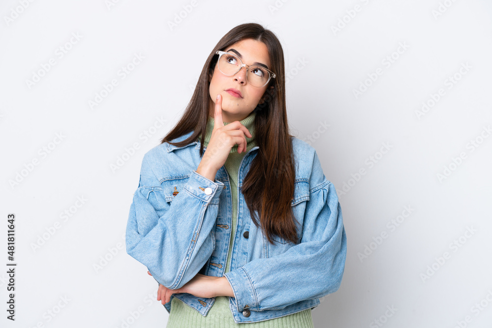 Young Brazilian woman isolated on white background having doubts while looking up Young Brazilian woman isolated on white background having doubts while looking up