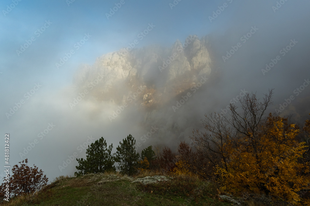 The slope of Demerdzhi Mountain peeks out from behind the fog