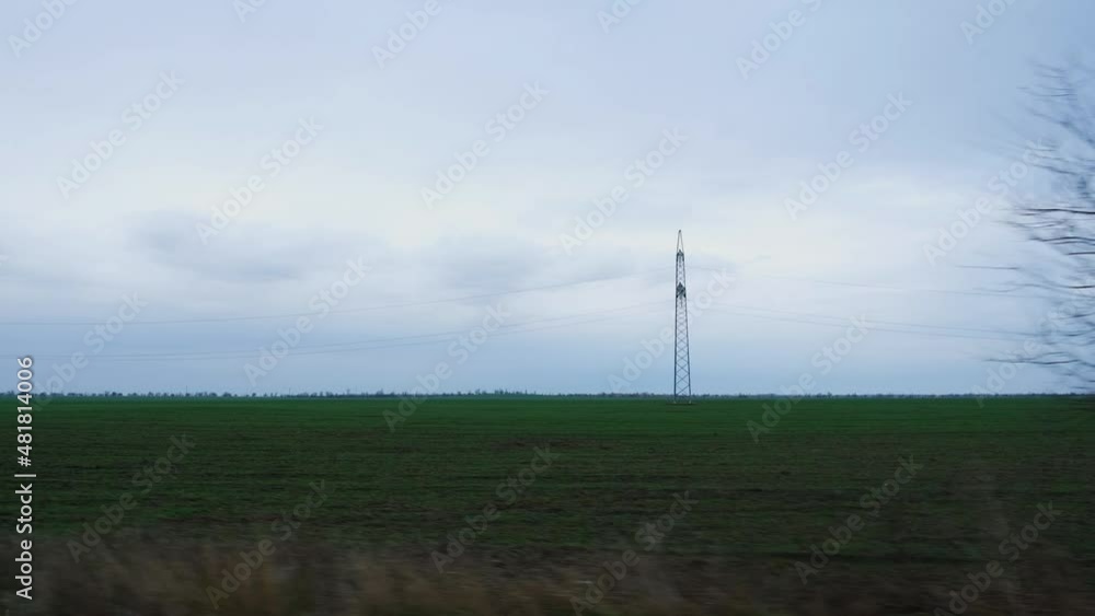 Green fields road car window. View from the side window of the green spring wheat fields and clouds floating across the blue sky. Travel on the roads of Russia, a breathtaking view from the car window Green fields road car window. View from the side window of the green spring wheat fields and clouds floating across the blue sky. Travel on the roads of Russia, a breathtaking view from the car window