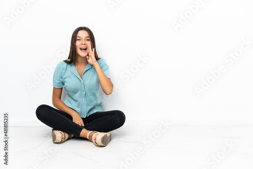 Free Download Teenager girl sitting on the floor shouting with mouth wide open - GFXLoad