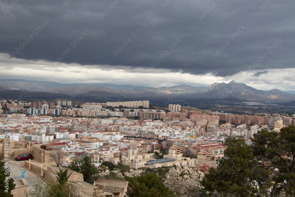 panorama view of the city under black rainy sky, view of Alicante