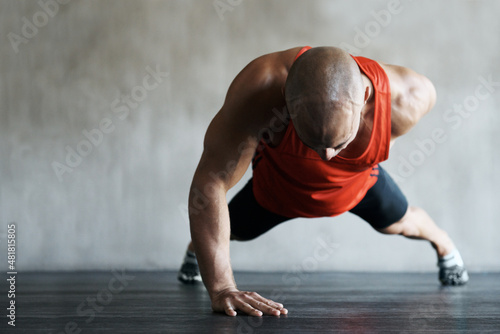 He's owning this workout. Shot of a man working out at the gym.