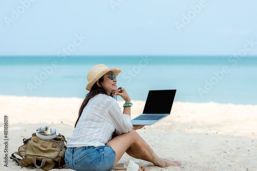 Lifestyle freelance woman using laptop working and relax on the beach.  Asian people success and together your work pastime and meeting conference on internet in holiday. Business and Summer Concept