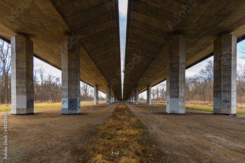 Central view from under of highway bridge with high concrete pillars © wierzchu92