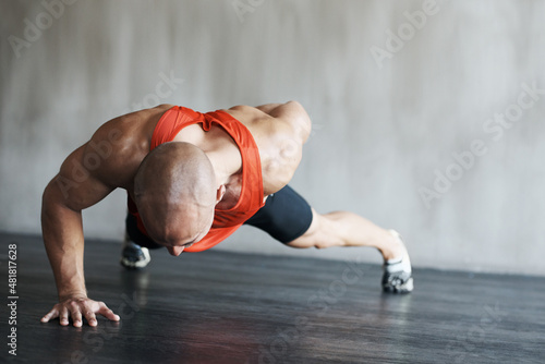 Training to become fighting fit. Shot of a man working out at the gym.