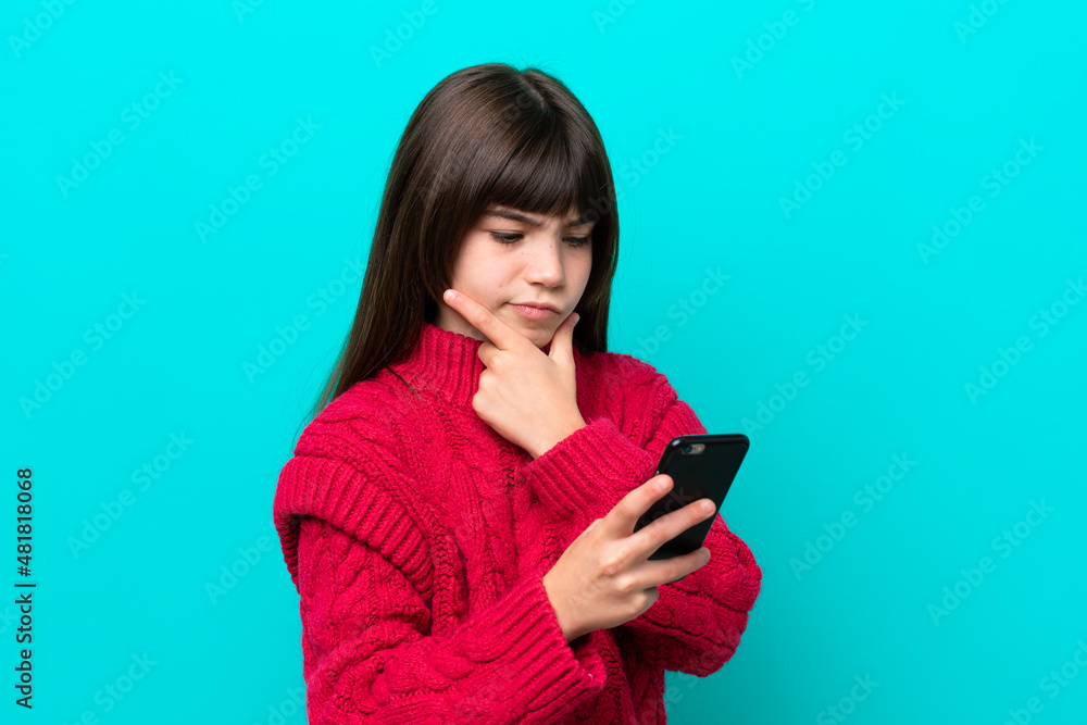 Little caucasian girl isolated on blue background thinking and sending a message Little caucasian girl isolated on blue background thinking and sending a message