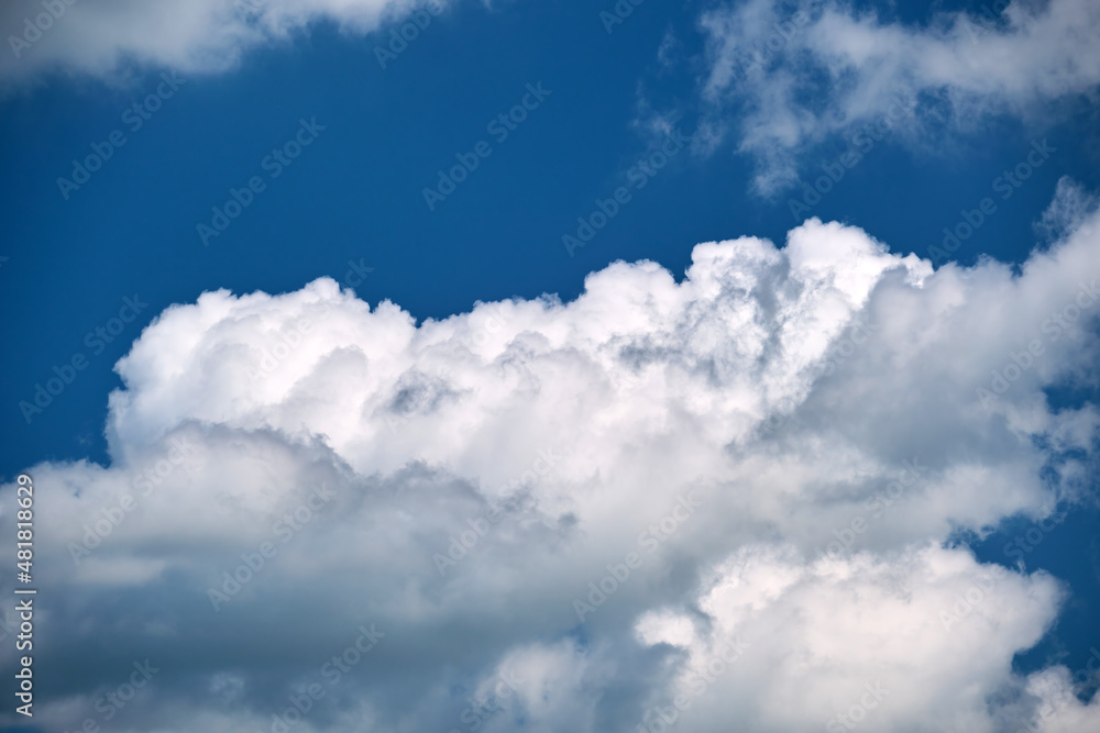 Bright landscape of white puffy cumulus clouds on blue clear sky Bright landscape of white puffy cumulus clouds on blue clear sky