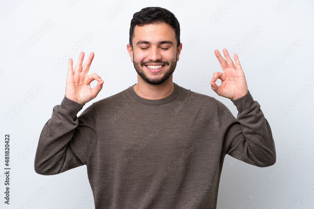 Young Brazilian man isolated on white background in zen pose Young Brazilian man isolated on white background in zen pose