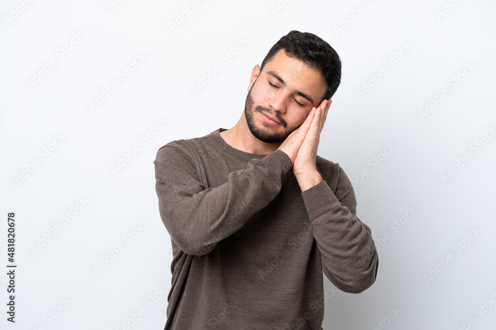 Young Brazilian man isolated on white background making sleep gesture in dorable expression Young Brazilian man isolated on white background making sleep gesture in dorable expression