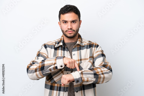 Young Brazilian man isolated on white background making the gesture of being late