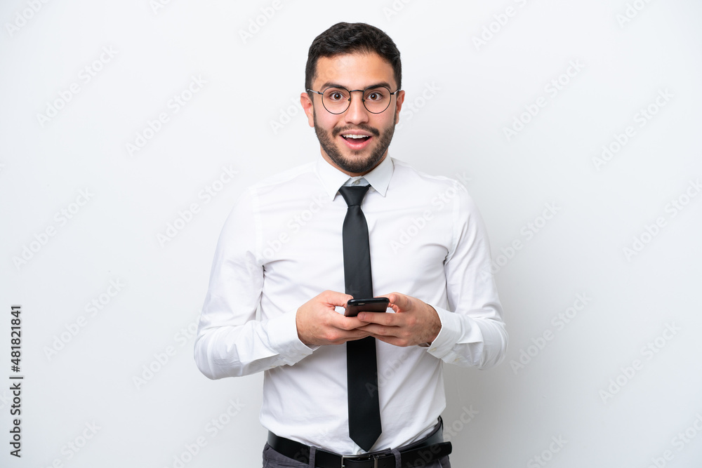 Business Brazilian man isolated on white background surprised and sending a message Business Brazilian man isolated on white background surprised and sending a message
