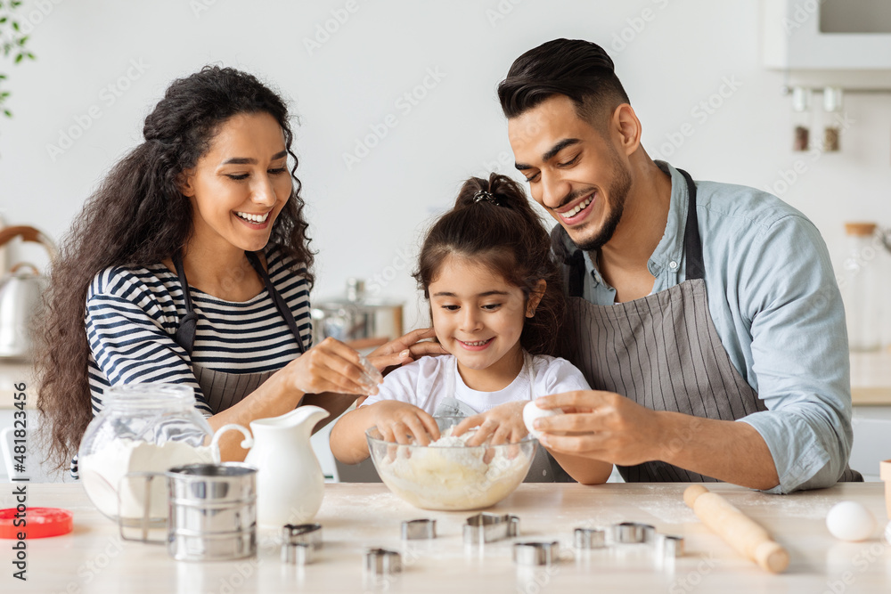 Adorable middle-eastern family making cookies at home Adorable middle-eastern family making cookies at home