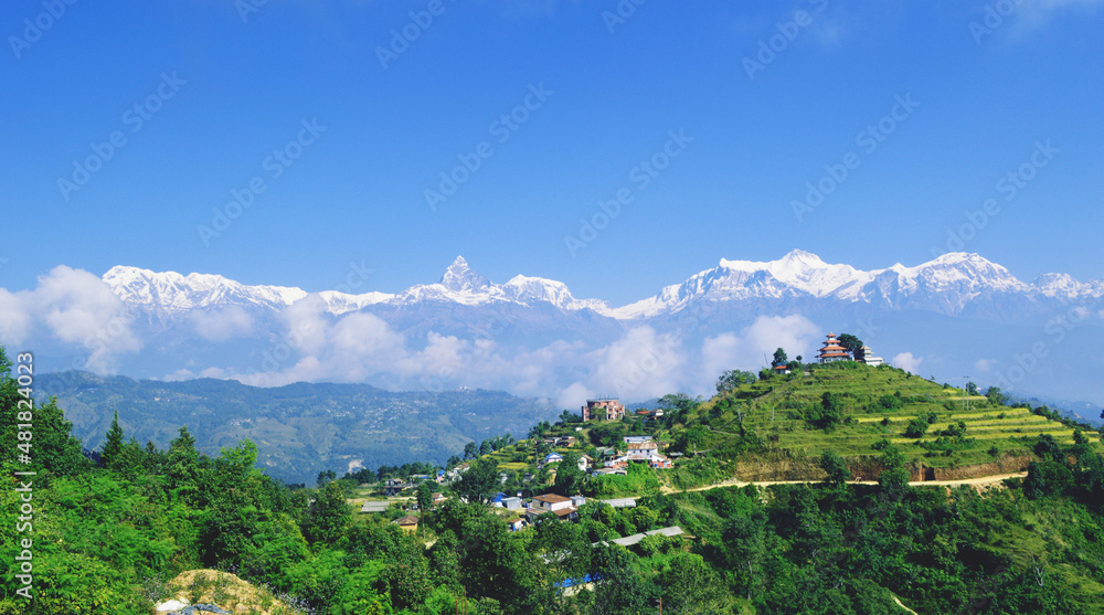 landscape with mountains and clouds: 
A beautiful view of mountain range of Annapurna and Fishtail with the temple on top of village Ramkot situated in Syangja district.
