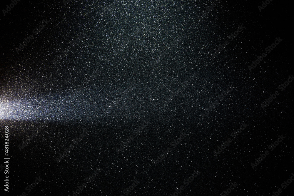 On a gradient grainy black background, a short horizontal beam of light On a gradient grainy black background, a short horizontal beam of light