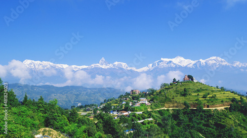 landscape with mountains and clouds: 
A beautiful view of mountain range of Annapurna and Fishtail with the temple on top of village Ramkot situated in Syangja district.