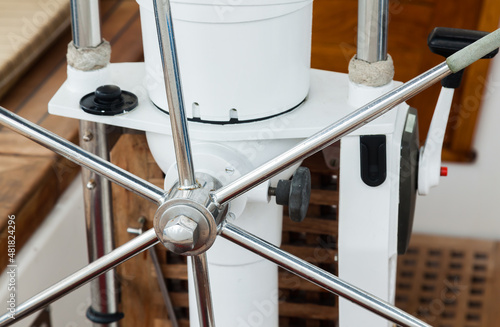 Stainless steel steering wheel on a sailing yacht, close-up.