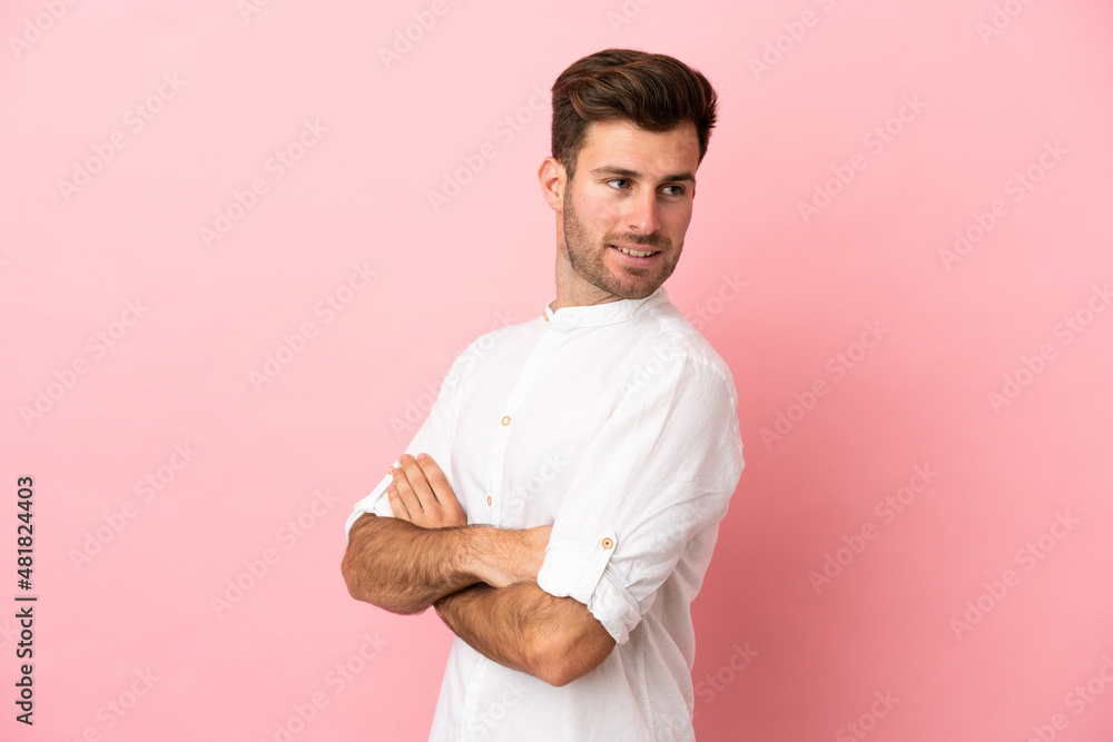 Young caucasian handsome man isolated on pink background with arms crossed and happy Young caucasian handsome man isolated on pink background with arms crossed and happy