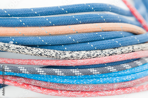 Multicolored ropes on a white background close-up.
