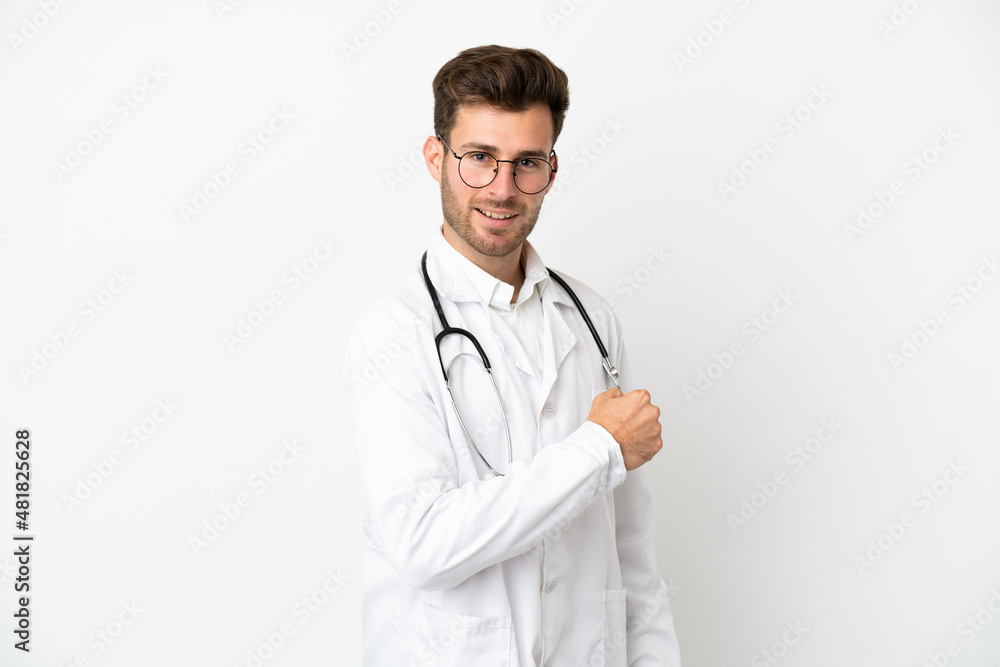 Fototapeta premium Young doctor caucasian man over isolated on white background wearing a doctor gown and making victory gesture