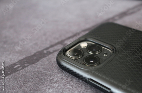 Three cameras detail on black mobile phone