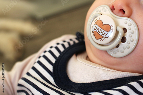 Baby girl with dummy in her mouth