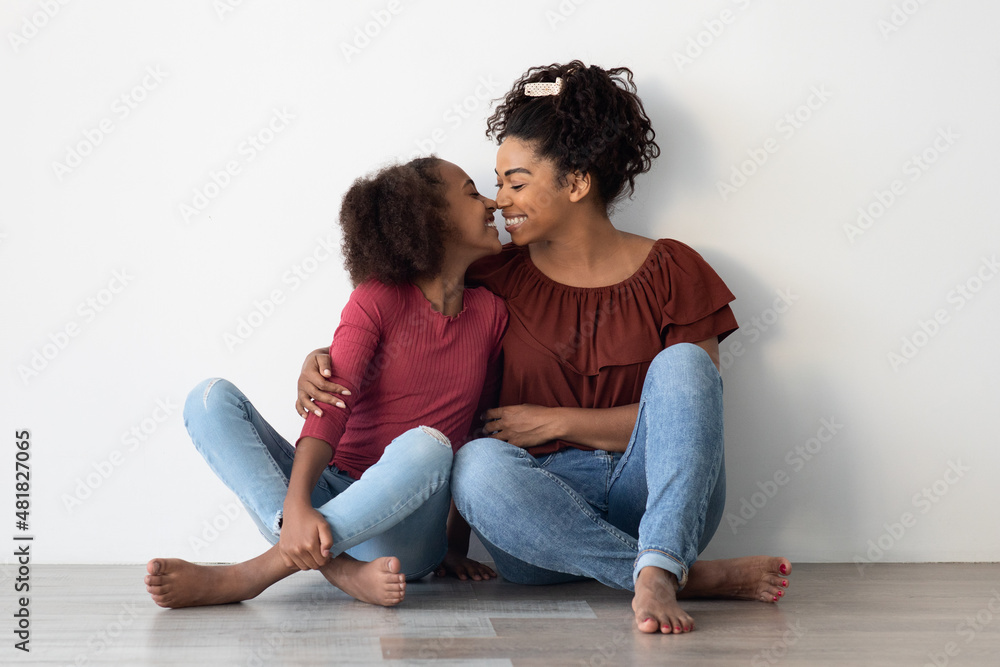 Loving black family sitting on floor at home Loving black family sitting on floor at home