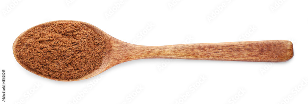 Wooden spoon with nutmeg powder on white background, top view Wooden spoon with nutmeg powder on white background, top view