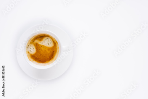 a white cup of coffee with a beautiful foam on a white background. 