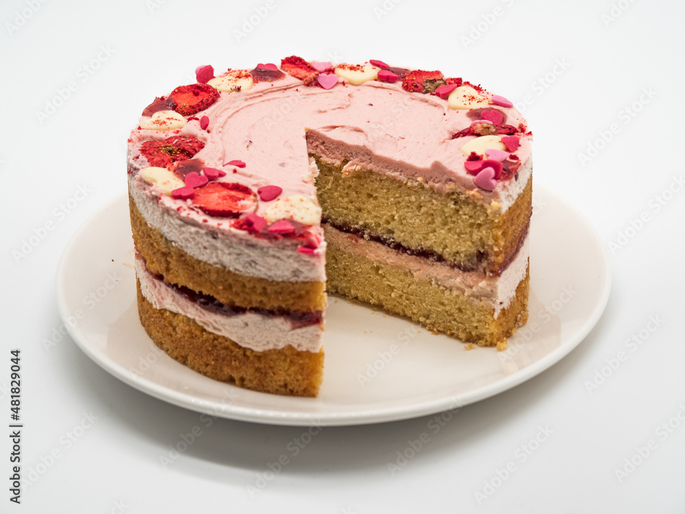 Valentine's day cake with cut strawberry, white background Valentine's day cake with cut strawberry, white background
