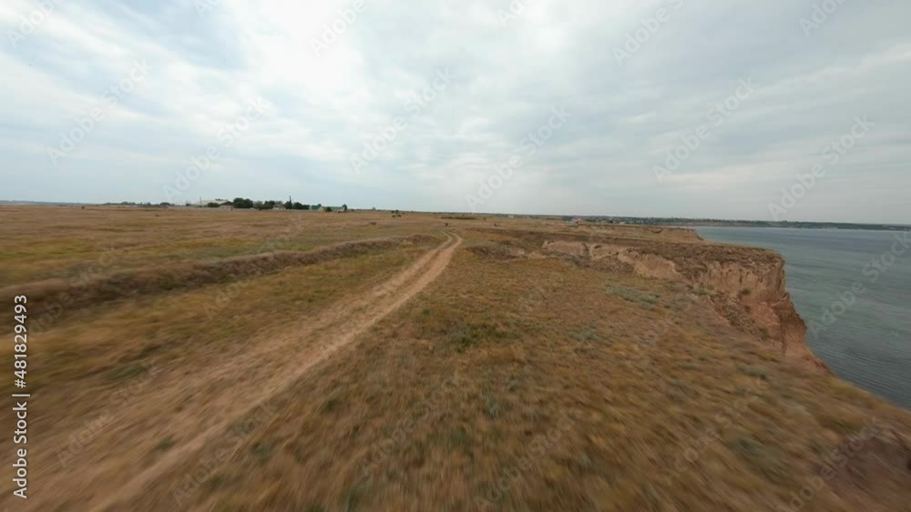 FPV flight over a coastal cliff at cloudy day FPV flight over a coastal cliff at cloudy day