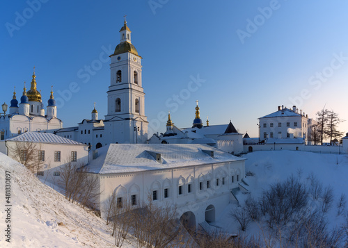 View of the ancient Siberian city of Tobolsk (Russia) on the hills on a winter sunny day. Panoramic view of the city with many ancient churches, golden domes, tall bell towers against a clear blue sky