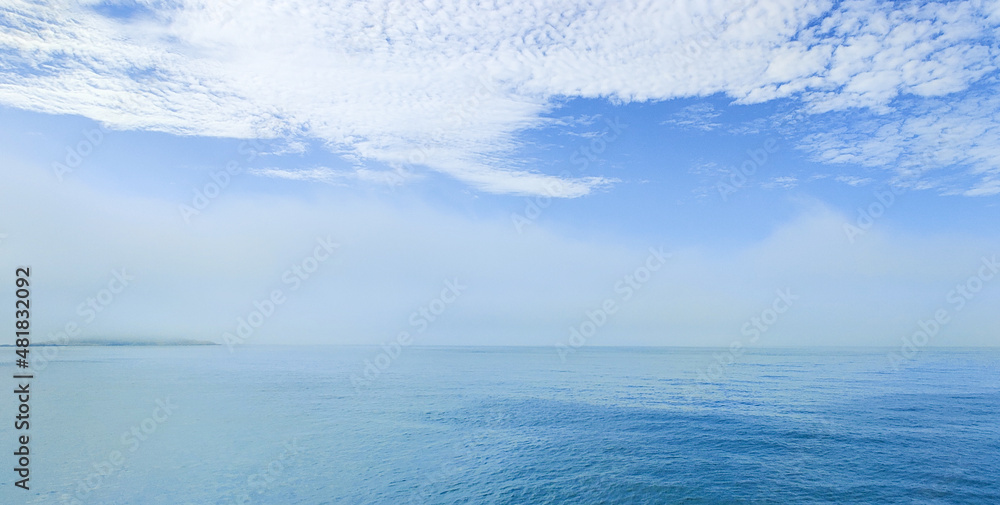 blue sea and sky with white clouds