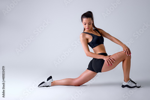 Caucasian Fitness woman doing lunges exercises for leg muscle workout training, isolated in studio. Active athlete woman doing one leg step lunge exercise for butt. sport and fitness concept